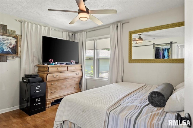 749 E Andrew Rd, Springfield, IL 62707 - bedroom featuring wood finished floors, a textured ceiling, and ceiling fan