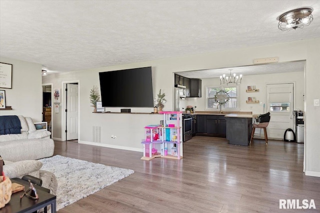 749 E Andrew Rd, Springfield, IL 62707 - living area featuring a chandelier, a textured ceiling, and dark wood-type flooring