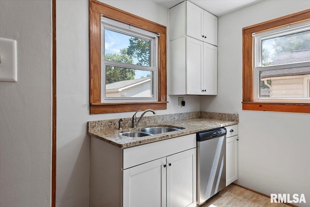 1529 W Reed Ave, Springfield, IL 62704 - kitchen with stainless steel dishwasher, light stone countertops, and white cabinetry