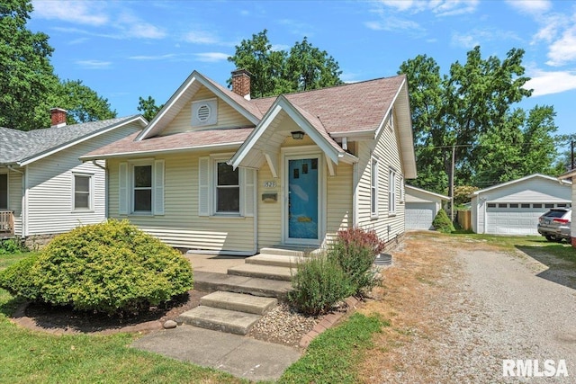 1529 W Reed Ave, Springfield, IL 62704 - bungalow with a chimney, a garage, an outbuilding, and roof with shingles