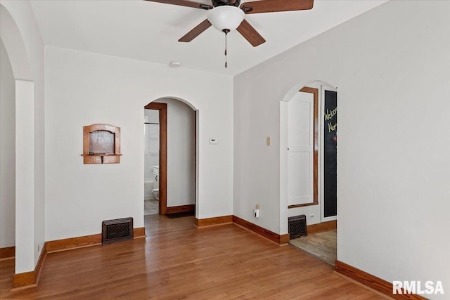 1529 W Reed Ave, Springfield, IL 62704 - unfurnished room featuring ceiling fan, arched walkways, and light wood-type flooring