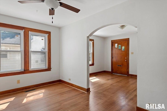 1529 W Reed Ave, Springfield, IL 62704 - empty room with arched walkways, plenty of natural light, wood finished floors, and a ceiling fan
