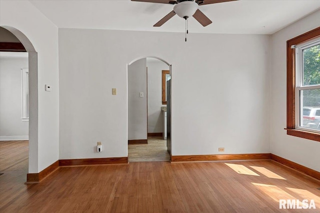 1529 W Reed Ave, Springfield, IL 62704 - unfurnished room featuring ceiling fan, arched walkways, and wood finished floors