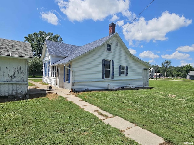 75 N County Road 830 N, Mendon, IL 62351 - view of front of property featuring a front yard, a chimney, and a shingled roof