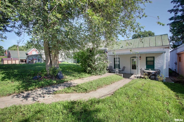 624 Monroe St, Quincy, IL 62301 - rear view of property with a standing seam roof, a lawn, a patio area, and a metal roof