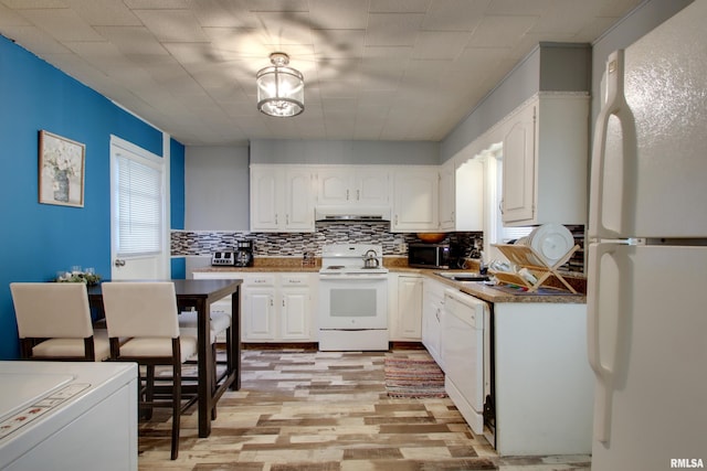 624 Monroe St, Quincy, IL 62301 - kitchen with white appliances, under cabinet range hood, white cabinets, and tasteful backsplash