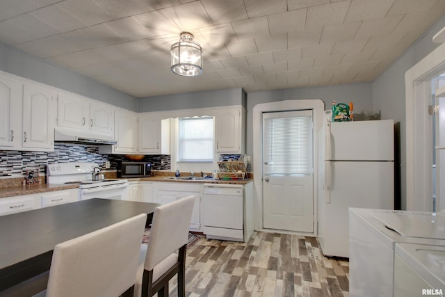 624 Monroe St, Quincy, IL 62301 - kitchen with white appliances, under cabinet range hood, light wood-style floors, white cabinets, and washing machine and dryer
