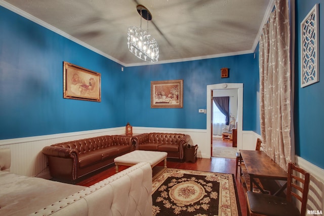 624 Monroe St, Quincy, IL 62301 - living area with wainscoting, wood finished floors, crown molding, and a chandelier