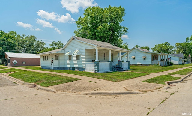 1231 Pulaski St, Lincoln, IL 62656 - bungalow-style home with a porch and a front yard