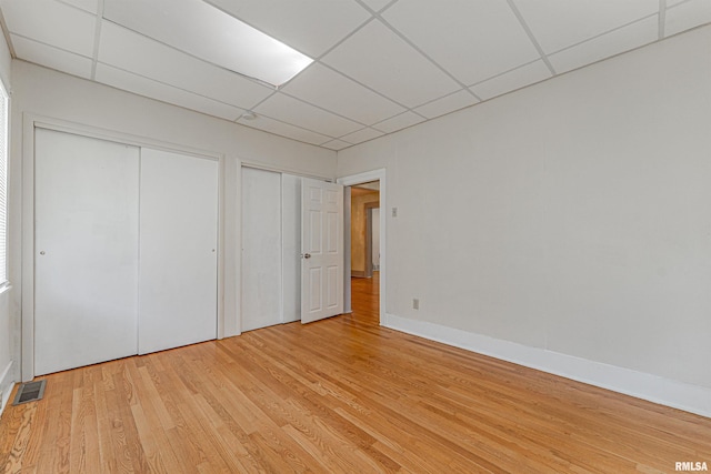 1231 Pulaski St, Lincoln, IL 62656 - unfurnished bedroom with a drop ceiling and light wood finished floors