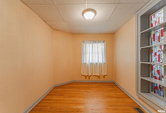 1231 Pulaski St, Lincoln, IL 62656 - spare room featuring a drop ceiling and wood finished floors