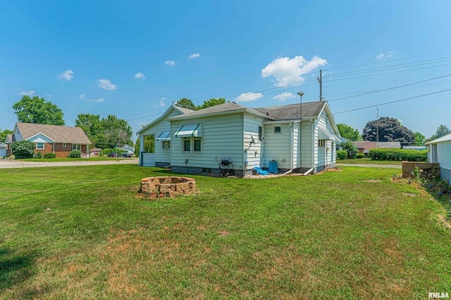 1231 Pulaski St, Lincoln, IL 62656 - view of side of property featuring a yard and a fire pit