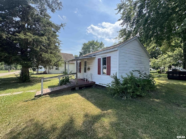 103 S Jackson St, Lincoln, IL 62656 - view of front of property with a front lawn and a deck