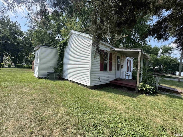 103 S Jackson St, Lincoln, IL 62656 - view of home's exterior featuring a lawn and a wooden deck
