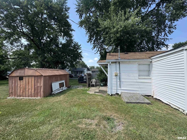103 S Jackson St, Lincoln, IL 62656 - view of green lawn featuring a storage unit