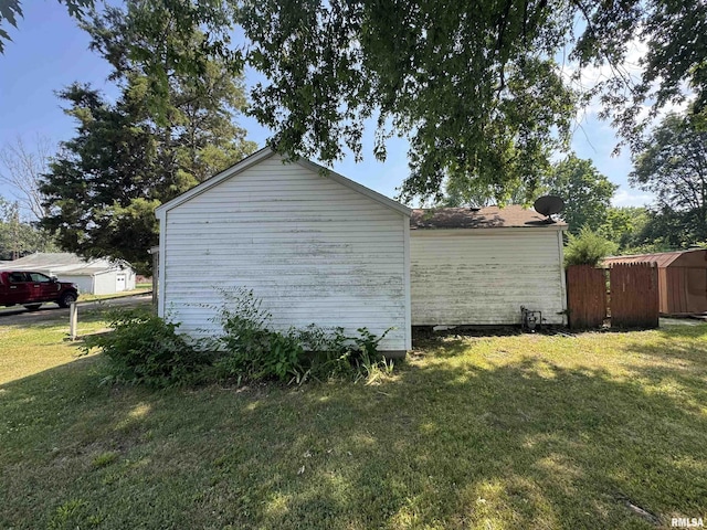 103 S Jackson St, Lincoln, IL 62656 - view of side of property with a yard and a storage unit