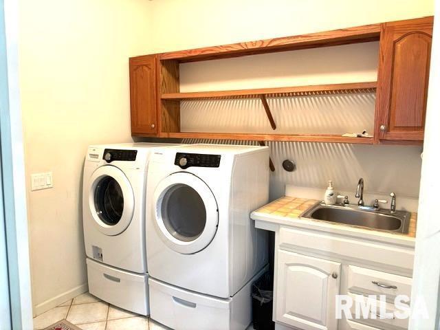 4317 Harvard Dr, Springfield, IL 62712 - washroom featuring washing machine and clothes dryer, cabinet space, light tile patterned flooring, and wet bar