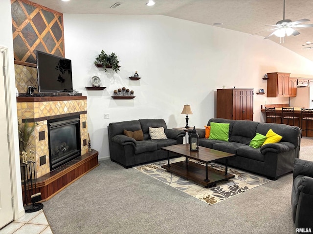 4317 Harvard Dr, Springfield, IL 62712 - living area with vaulted ceiling, ceiling fan, light carpet, a tiled fireplace, and recessed lighting