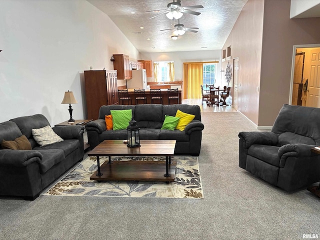 4317 Harvard Dr, Springfield, IL 62712 - living room with carpet floors, ceiling fan, vaulted ceiling, and a textured ceiling
