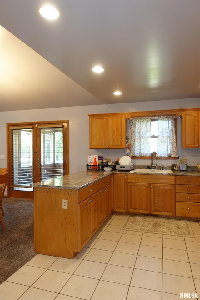 1156 Russell Ave, Galesburg, IL 61401 - kitchen with a peninsula, plenty of natural light, light tile patterned floors, recessed lighting, and brown cabinets