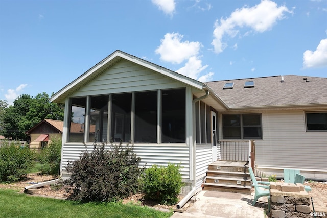 1156 Russell Ave, Galesburg, IL 61401 - rear view of house with a sunroom and a shingled roof