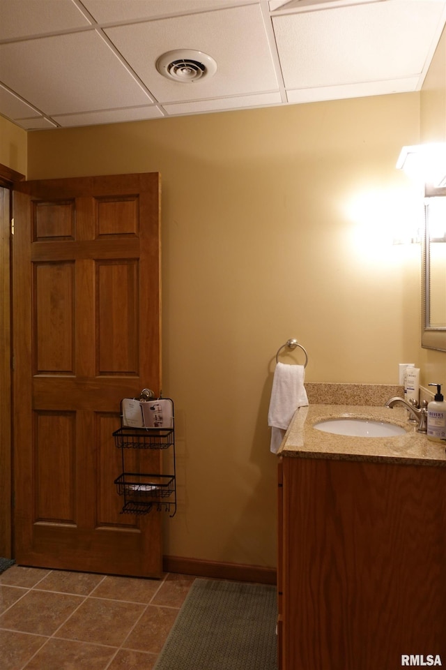 1156 Russell Ave, Galesburg, IL 61401 - bathroom featuring vanity, tile patterned flooring, and a paneled ceiling