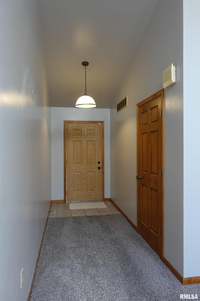 1156 Russell Ave, Galesburg, IL 61401 - doorway to outside featuring vaulted ceiling, light colored carpet, and light tile patterned floors