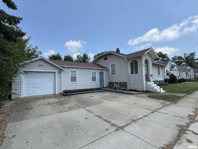 839 E Fremont St, Galesburg, IL 61401 - view of front of house with concrete driveway, an attached garage, and a chimney