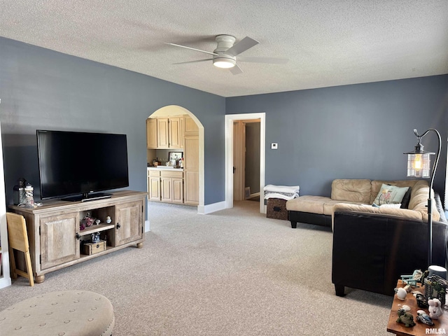 839 E Fremont St, Galesburg, IL 61401 - living room with a ceiling fan, light carpet, arched walkways, and a textured ceiling