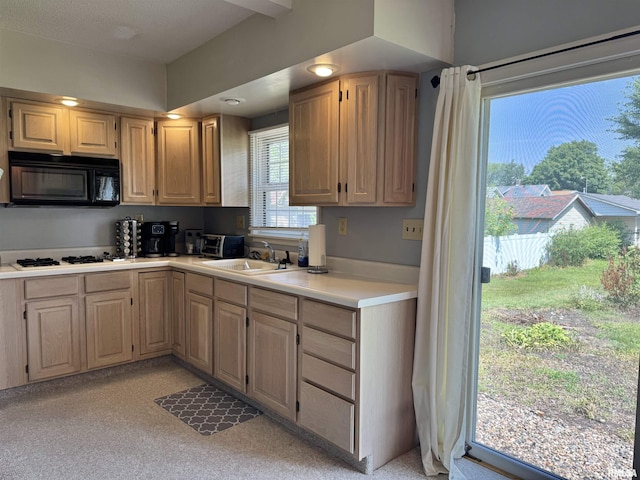839 E Fremont St, Galesburg, IL 61401 - kitchen featuring black microwave, light countertops, cooktop, and light brown cabinetry