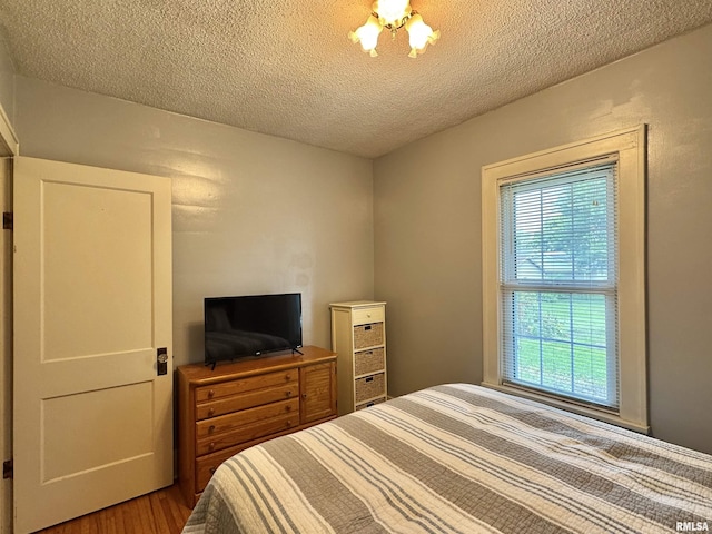 839 E Fremont St, Galesburg, IL 61401 - bedroom with multiple windows, a textured ceiling, and wood finished floors