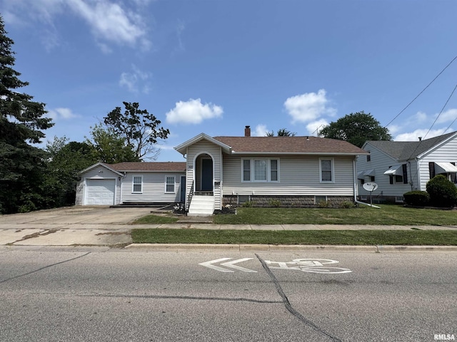 839 E Fremont St, Galesburg, IL 61401 - view of front facade featuring driveway, a front yard, and a chimney