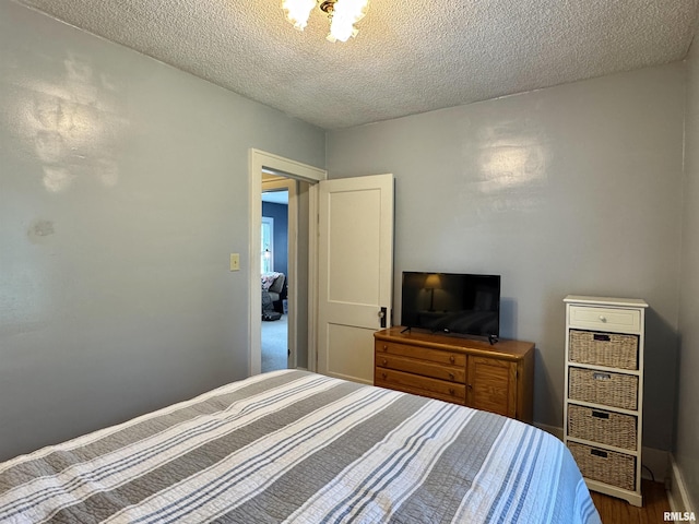 839 E Fremont St, Galesburg, IL 61401 - bedroom with a textured ceiling and wood finished floors