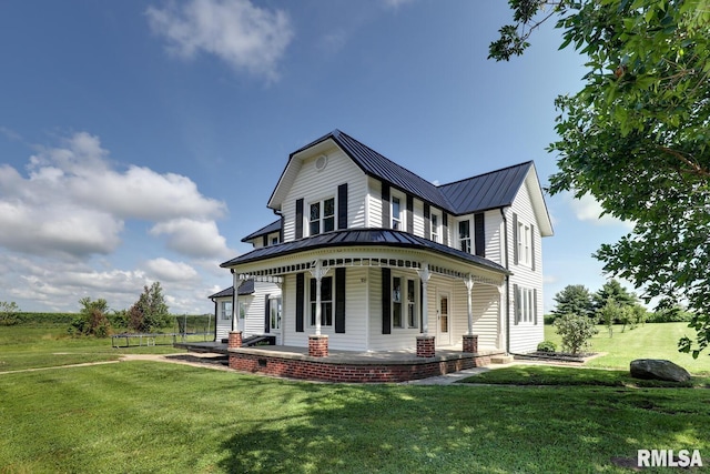 281 N Ave, Plainville, IL 62365 - view of front of house with a standing seam roof, a porch, a front yard, and a metal roof