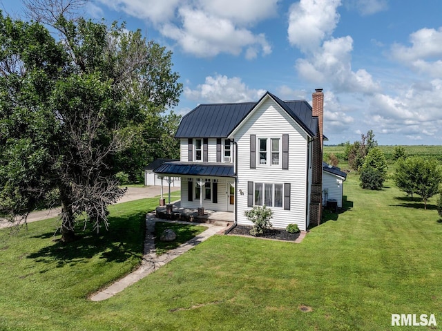 281 N Ave, Plainville, IL 62365 - rear view of property featuring covered porch, a chimney, a metal roof, a yard, and a standing seam roof