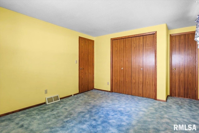15858 Oak Ln, Girard, IL 62640 - unfurnished bedroom with carpet flooring and two closets