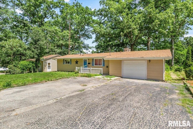 15858 Oak Ln, Girard, IL 62640 - ranch-style home featuring asphalt driveway, a chimney, and a garage