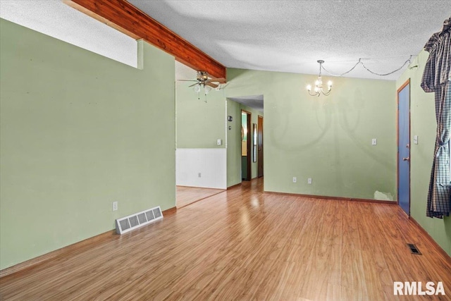 15858 Oak Ln, Girard, IL 62640 - spare room featuring a chandelier, wood finished floors, a textured ceiling, and ceiling fan