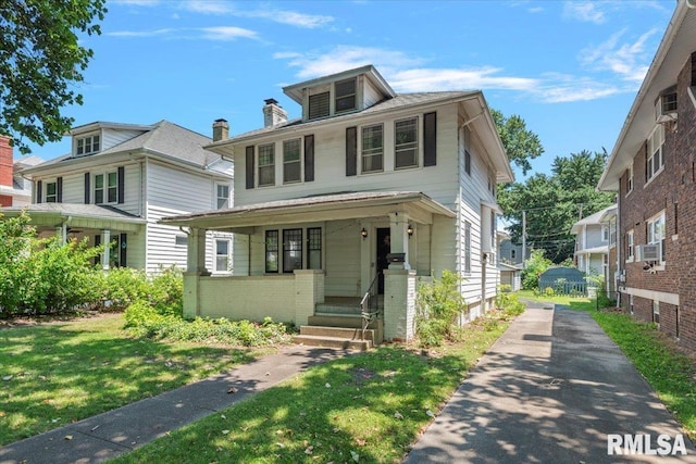 1424 S Lowell Ave, Springfield, IL 62704 - traditional style home with covered porch, driveway, a front yard, and cooling unit