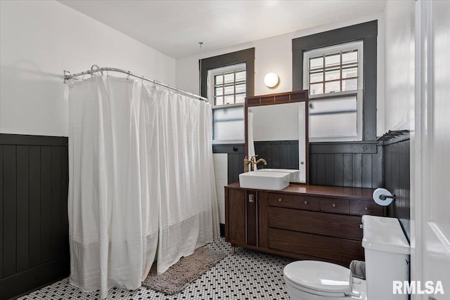 1424 S Lowell Ave, Springfield, IL 62704 - bathroom featuring wainscoting, vanity, and curtained shower