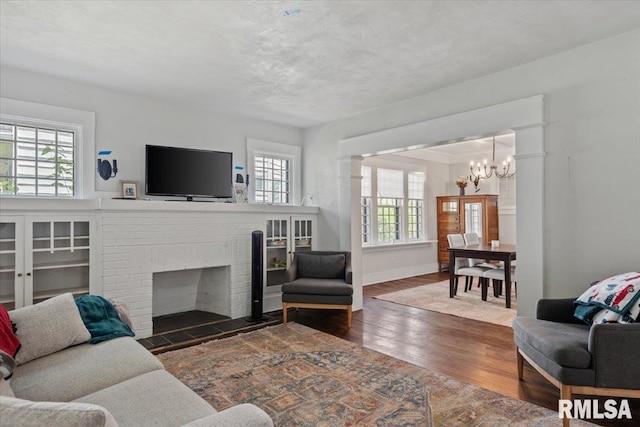 1424 S Lowell Ave, Springfield, IL 62704 - living room with plenty of natural light, a chandelier, wood finished floors, and a fireplace