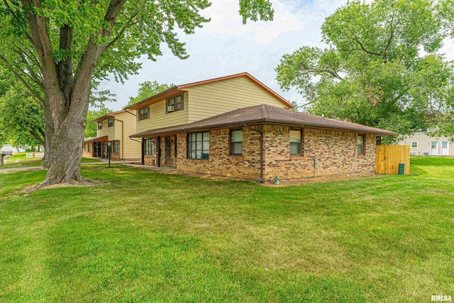 147 Northville Dr, Lincoln, IL 62656 - rear view of house with brick siding and a yard