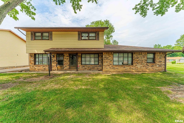 147 Northville Dr, Lincoln, IL 62656 - view of front of home featuring brick siding, a front yard, and a patio area