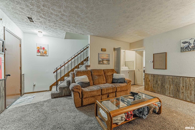 147 Northville Dr, Lincoln, IL 62656 - living room with a textured ceiling, stairs, carpet flooring, and washer / dryer