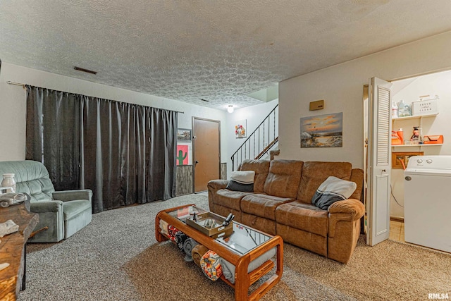 147 Northville Dr, Lincoln, IL 62656 - carpeted living room with a textured ceiling, stairs, and washer / dryer