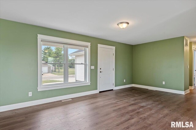 210 Prairie Run, Illiopolis, IL 62539 - spare room featuring dark wood-type flooring