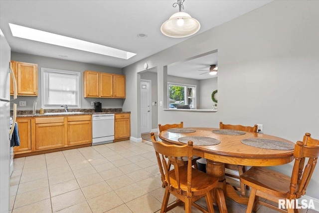 3328 Mars Ave, Springfield, IL 62707 - kitchen featuring white dishwasher, light tile patterned floors, a skylight, and dark countertops