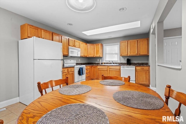 3328 Mars Ave, Springfield, IL 62707 - kitchen featuring white appliances, light tile patterned flooring, and dark countertops