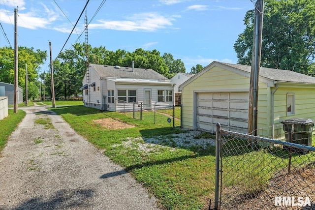 2912 E Enos Ave, Springfield, IL 62702 - rear view of house featuring driveway, an outdoor structure, and a garage
