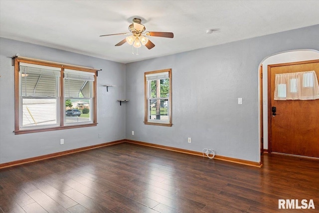 2912 E Enos Ave, Springfield, IL 62702 - empty room with arched walkways, a ceiling fan, and wood finished floors